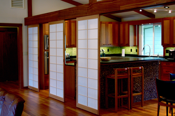 Shoji screens are installed with roller tracking above and float on spring loaded guide pins that engage a channel routed into the flooring.