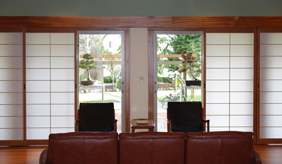 Opposite from the kitchen a wall of shoji screens provide light and privacy across the expanse of windows & sliding glass doors.