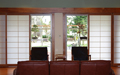 Opposite from the kitchen a wall of shoji screens provide light and privacy across the expanse of windows & sliding glass doors.